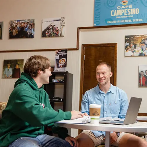 Students having a conversation at table