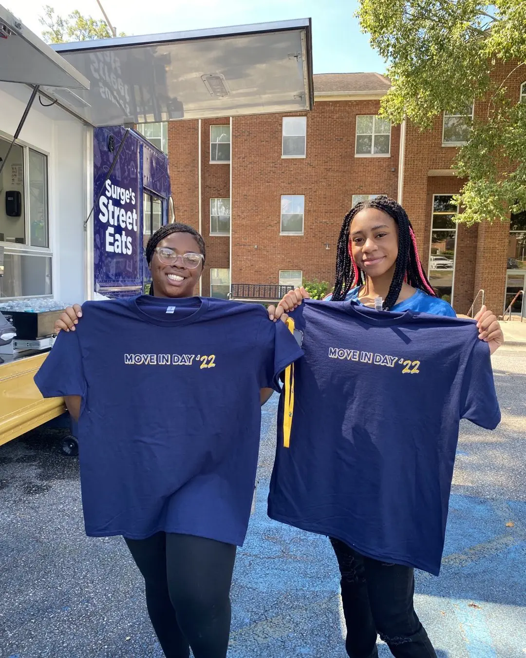 Students holding up shirts