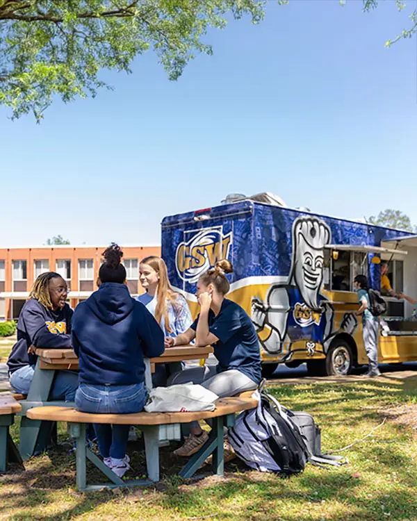 Students sitting at picnic table
